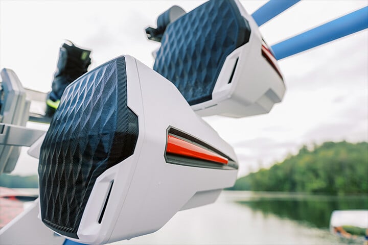 White and red Rev-12 speakers on a blue tower on a Malibu Wakesetter