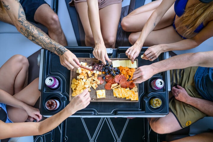 Friends having a snack on the table setting of the MaxPivot Seat™