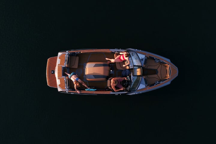 Interior of a Malibu TXi Response ski boat from above as a skier prepares to ride Interior of a Malibu TXi Response ski boat from above as a skier prepares to ride